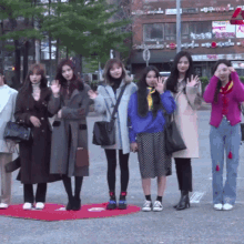 a group of young women standing in front of a building with a sign that says ' korean ' on it