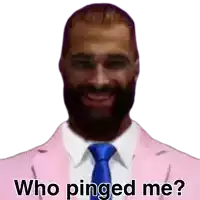 a man with a beard is wearing a pink suit and a blue tie and says who pinged me