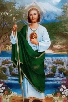 a painting of jesus holding a cross and a green robe