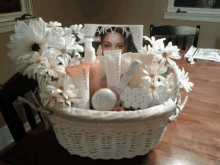 a basket filled with mary kay products and flowers on a table .