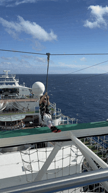 a person is riding a zip line on the deck of a cruise ship