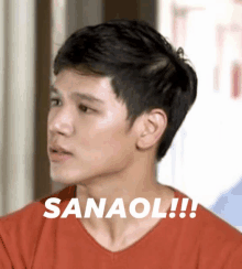 a man in a red shirt with the word sanaol written on his face