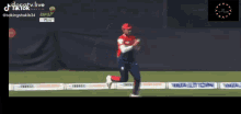 a man in a red and white uniform is running on a field with a bpl logo in the background