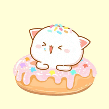 a cartoon cat is sitting on top of a pink frosted donut with sprinkles