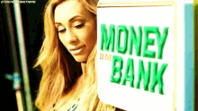 a woman is standing in front of a box that says money in the bank