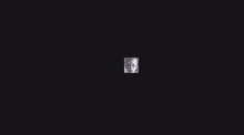 a black background with a picture of a person 's face