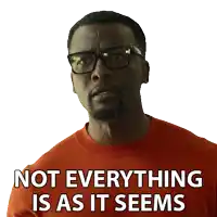 a man wearing glasses and an orange shirt with the words not everything is as it seems