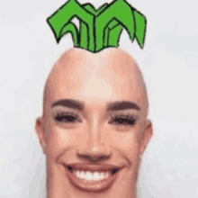 a bald man with a green crown on his head .