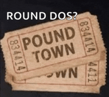 two tickets for pound town are stacked on top of each other on a black background .