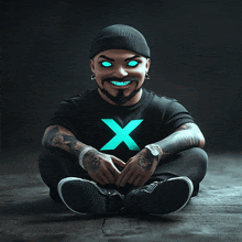 a man wearing a black shirt with an x on it sits on the floor