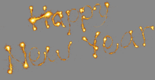 the words happy new year are written in sparklers on a gray background