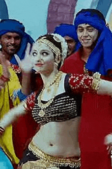 a woman is dancing in front of a crowd of people wearing blue turbans .