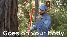 a man in a blue shirt holding a red stick with the words " goes on your body " on the bottom