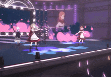 a group of girls are dancing on a stage in a video game