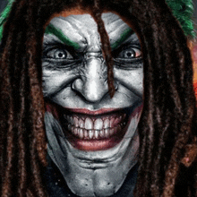 a close up of a joker 's face with dreadlocks and green eyebrows