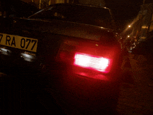 a car with license plate number 7 ra 077