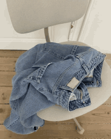 a pair of jeans on a chair with a tag that says ' denim ' on it