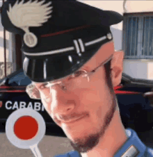 a man wearing a carabinieri hat and glasses