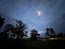 a lightning bolt is visible in the night sky above a residential area