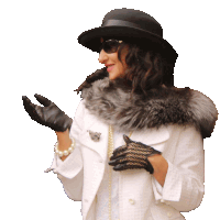 a woman wearing a hat sunglasses and gloves