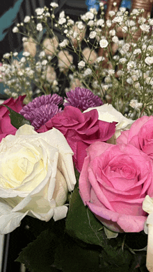 a bunch of pink and white flowers with baby 's breath