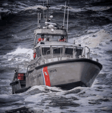 a u.s. coast guard boat is floating in the ocean