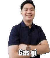 a man in a blue polo shirt is standing with his arms crossed and says gas gi .