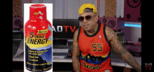 a man wearing a nuggets jersey stands next to a bottle of berry 5 hour energy