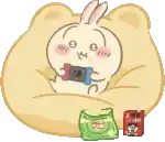 a cartoon rabbit is sitting on a pillow holding a nintendo switch .