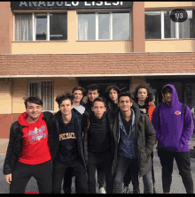 a group of young men standing in front of an anadolu lisesi