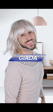 a man wearing a wig and a lace collar is called giada