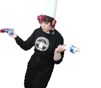 a woman wearing a nasa shirt and a chef 's hat is dancing