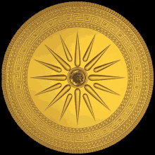 a gold coin with a star in the center has a greek key pattern around it