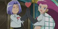 a man and a woman are holding a red heart in their hands