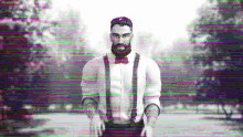 a man with a beard and suspenders stands in front of a blurry background