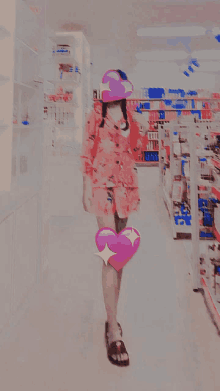 a woman in a pink dress is holding a pink heart on her leg