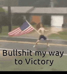 a man holding an american flag on the side of a road with the words bullshit my way to victory below him