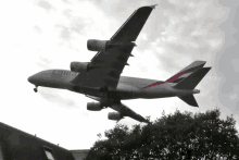 an emirates airplane is flying in the sky