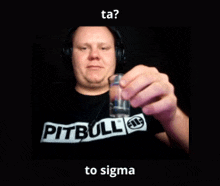 a man in a pit bull shirt holds a shot glass