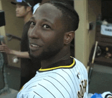 a man wearing a jersey that says ' dodgers ' on the back