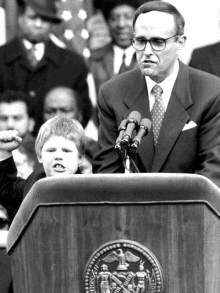 a man stands at a podium with a new york city seal on it