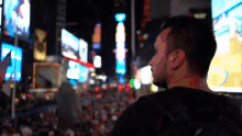 a man in a black shirt stands in front of a sign that says ' domino 's ' on it