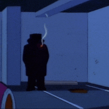 a man in a top hat smoking a cigarette in a dark room