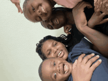 a woman and three children are posing for a picture