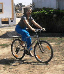 a woman is riding a bike with a basket on the back of it