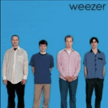 a group of men standing next to each other on a blue background with the word weezer on the bottom