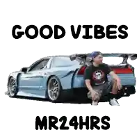 a man is sitting in front of a car with the words good vibes mr24hrs