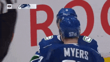 a hockey player named myers is wearing a blue helmet