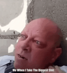 a bald man is making a funny face and says me when i take the biggest shit