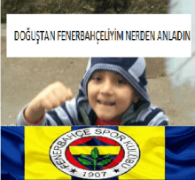 a boy in a hooded jacket is standing next to a yellow and blue flag that says fenerbahce spor kulübu 1907